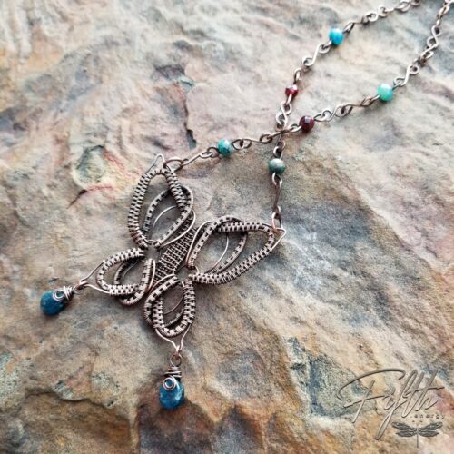 Copper butterfly necklace with apatite and garnet gemstones