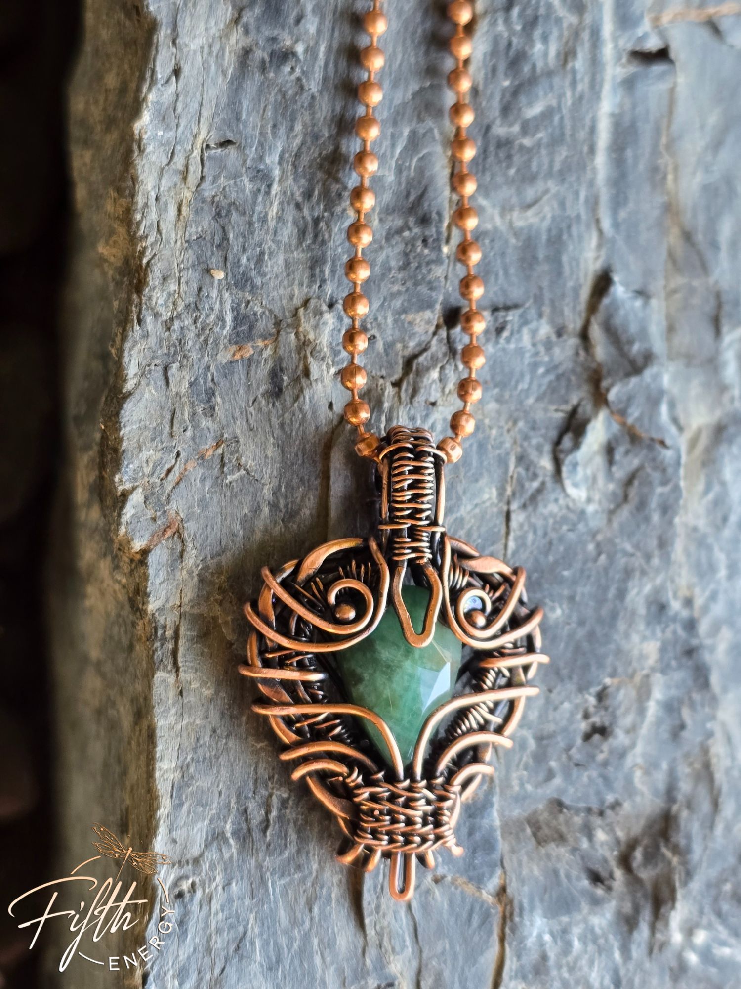 Copper Encased Emerald Necklace 9 Handmade USA-made emerald pendant necklace featuring a raw emerald stone secured in American-made copper. The rustic, artisanal wrap design makes this piece a unique gift for gemstone and copper jewelry collectors.