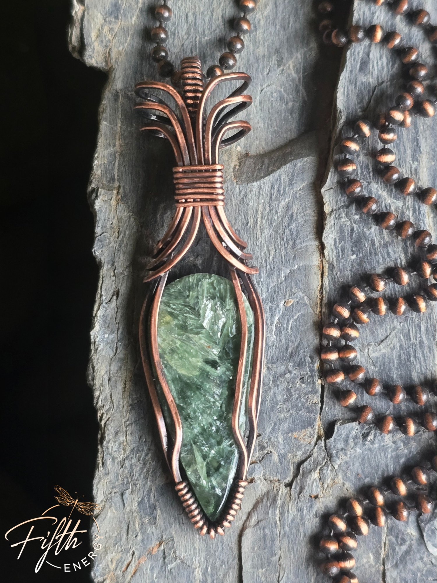 Seraphinite Necklace 2 Discover the Seraphinite Necklace by Fifth Energy Jewelry, featuring a shimmering deep green natural gemstone wrapped in handcrafted copper.