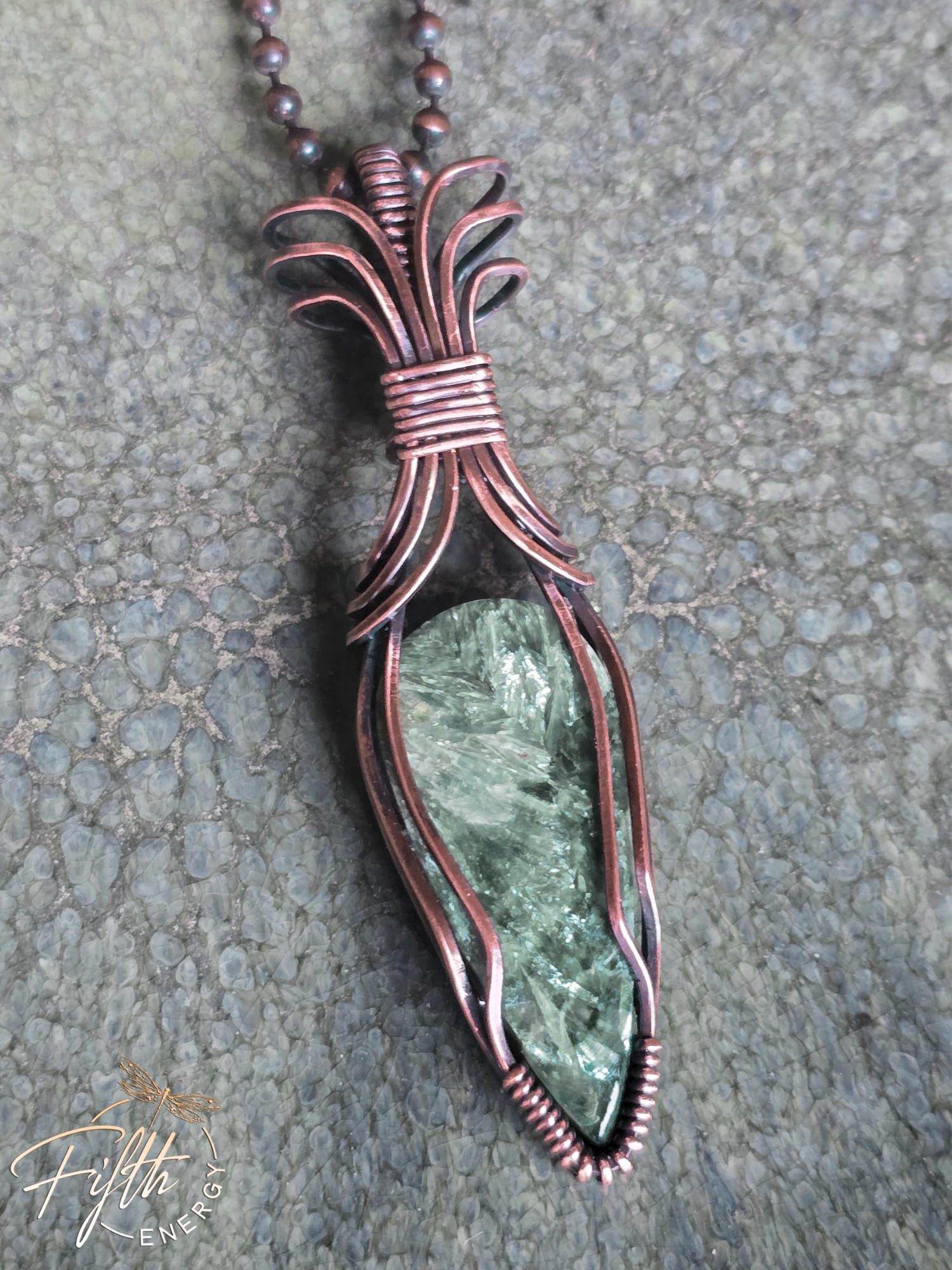 Seraphinite Necklace 5 This Seraphinite Necklace from Fifth Energy Jewelry showcases a shimmering all-natural green stone in a handmade copper setting.